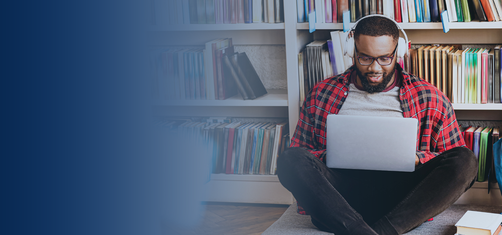 Man with headphones on using his laptop. 